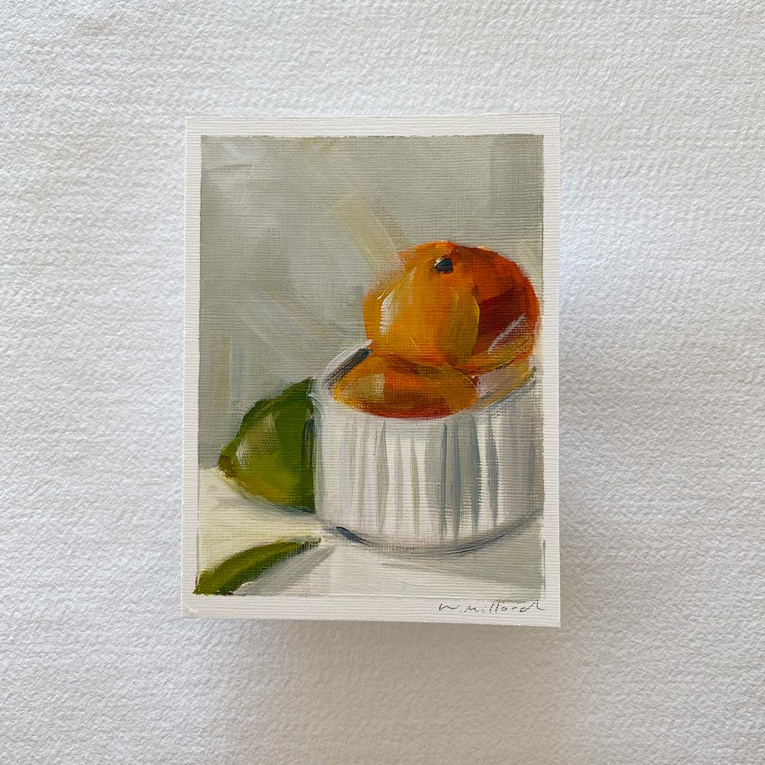 Clementines in bowl with a hint of lime